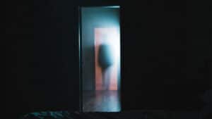 terrifying ghost in the doorway of a home.